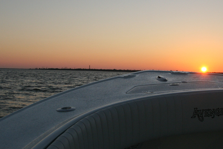 Photo of sunrise on custom bay boat headed for a trip
